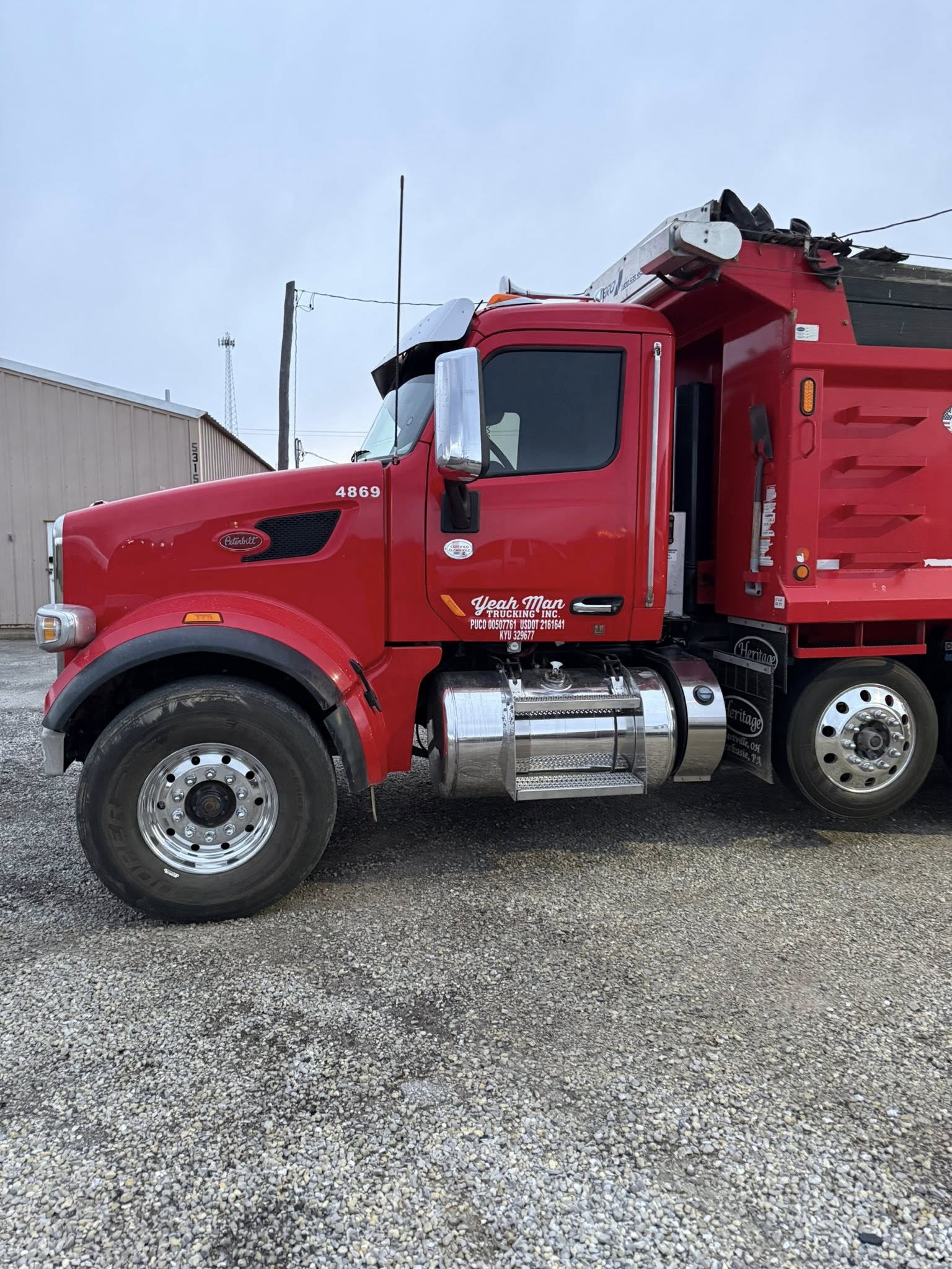 Red commercial dump truck with window tint installed by Bates Window Tint
