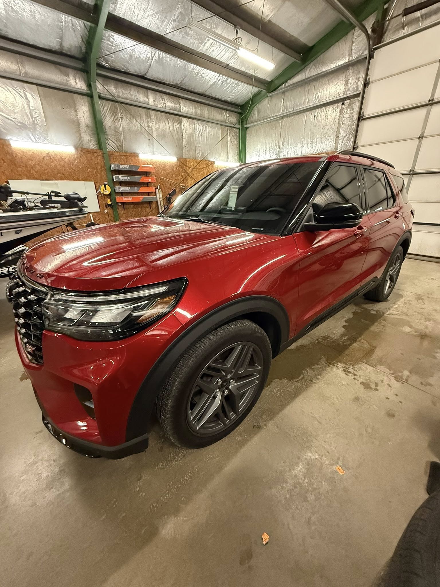 Red 2025 Ford Explorer ST with ceramic window tint, driver-side view in the shop