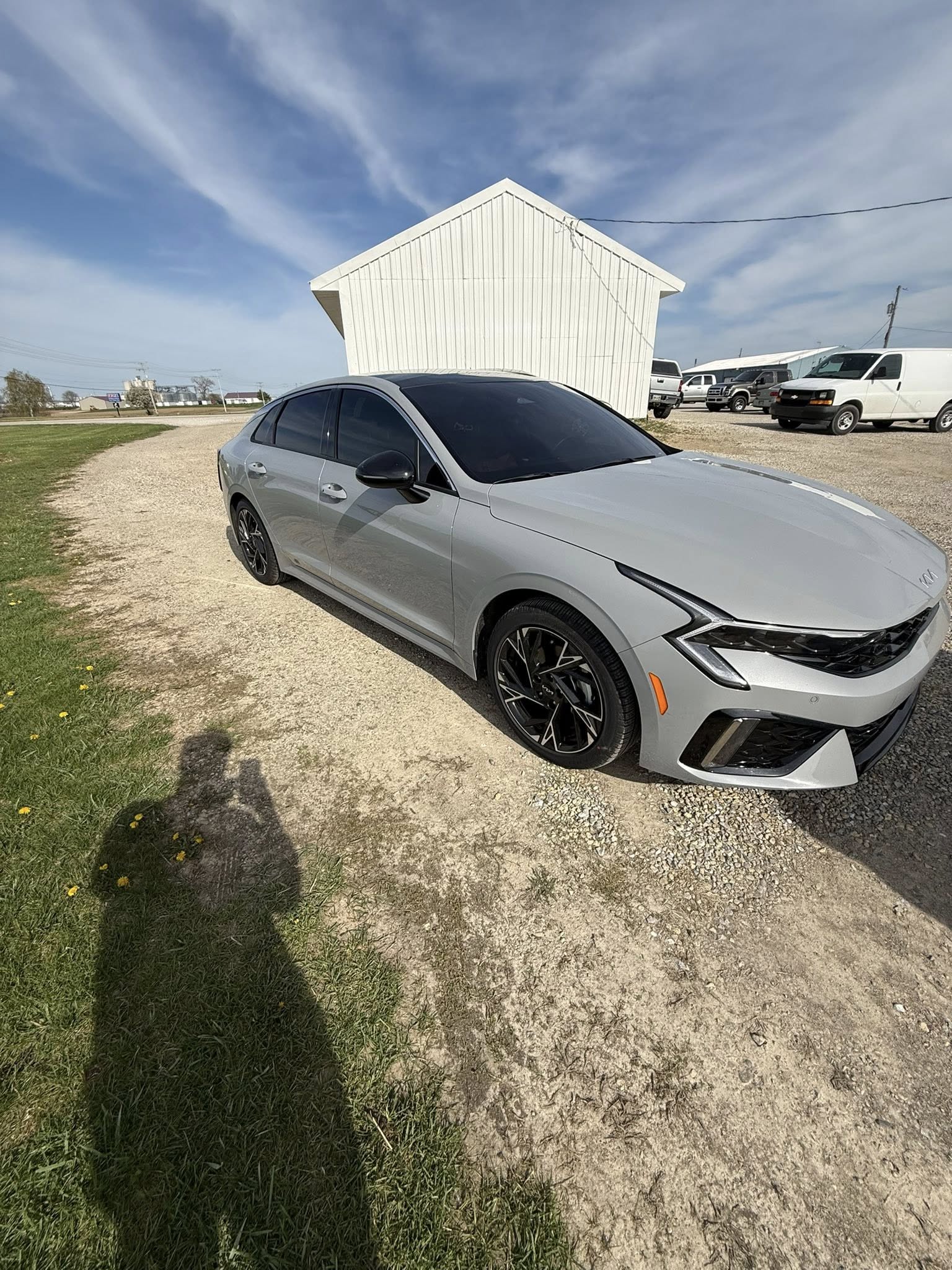 Silver sedan with fresh window tint, photographed outdoors against a clear sky